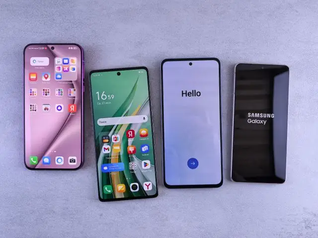 Four modern smartphones showcasing home screens, applications, and startup logos on a sleek surface.
