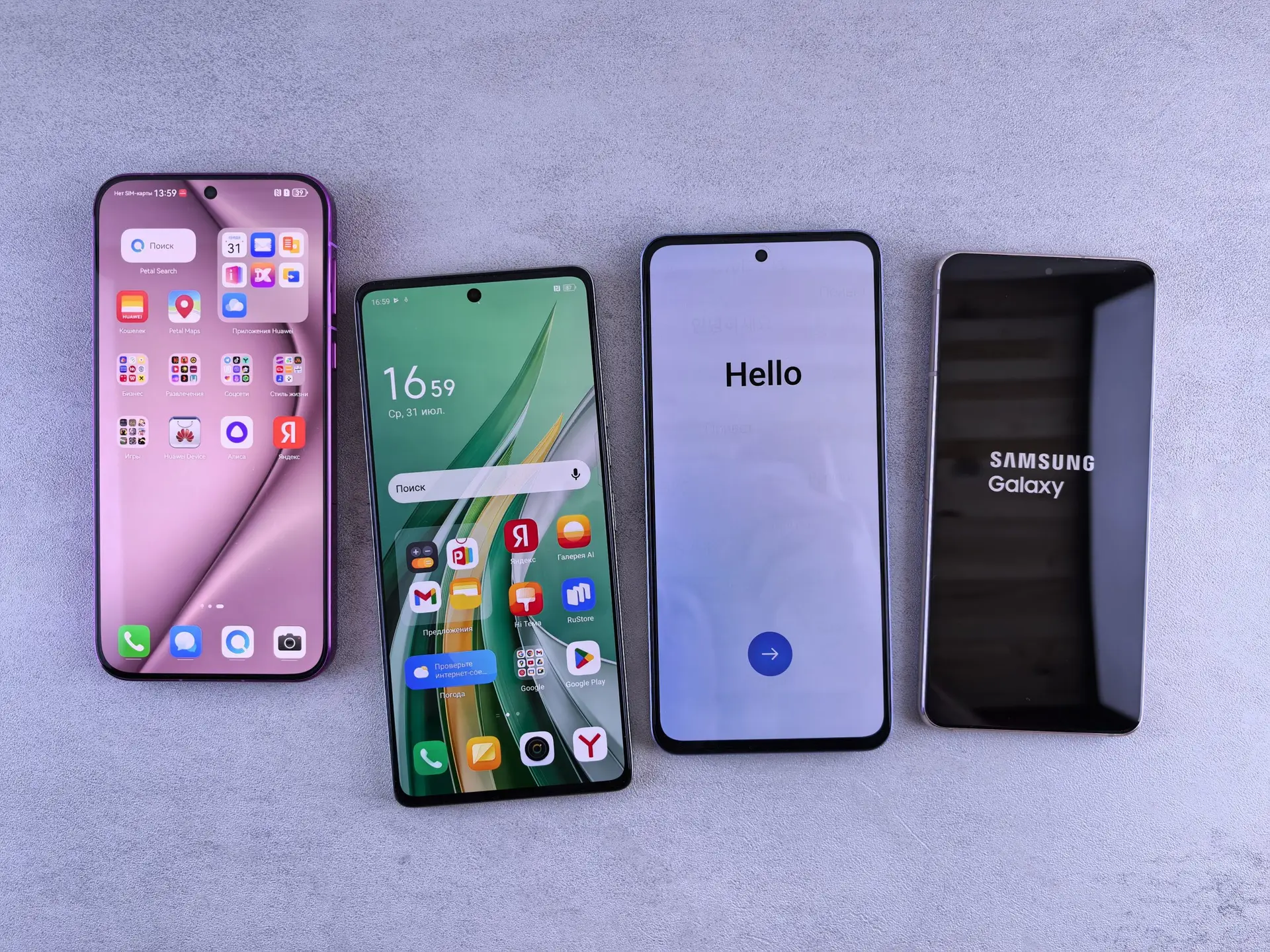 Four modern smartphones showcasing home screens, applications, and startup logos on a sleek surface.